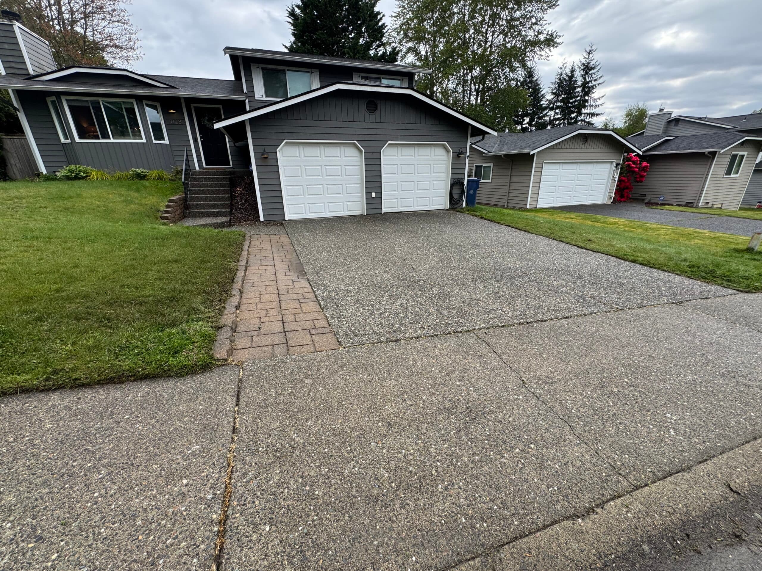 Clean exposed-aggregate driveway and home exterior ready for paint